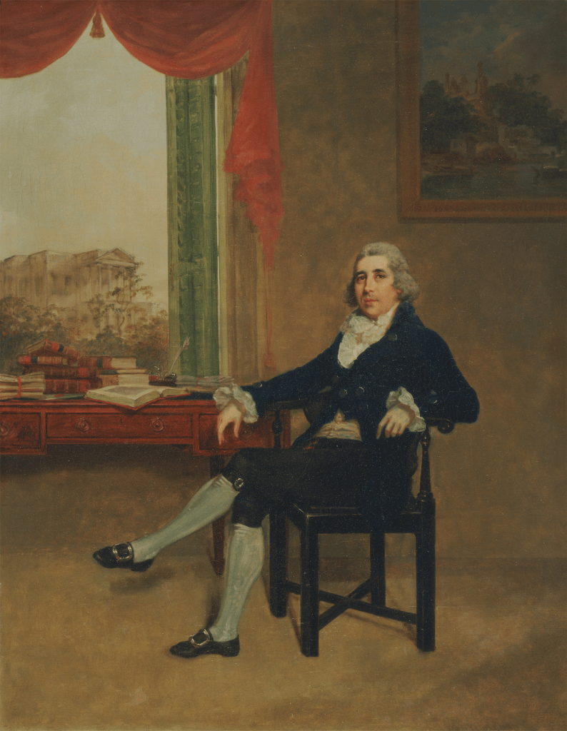 A historical portrait of a man sitting in a corner chair, dressed in 18th-century attire, with a table and books in the background.