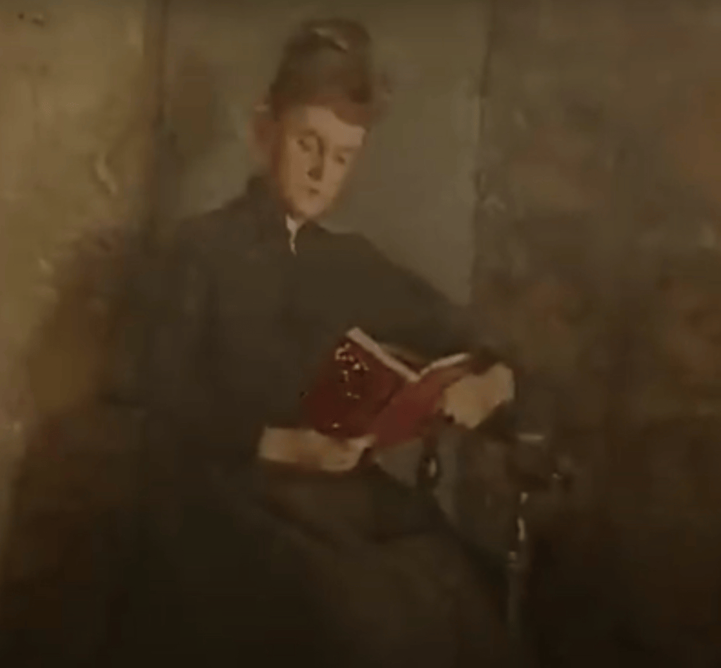 A historical image of a woman reading a book while seated in a corner chair, showcasing her traditional attire and the chair's unique design.